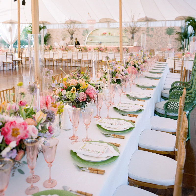 pink glasses with green plates table setting